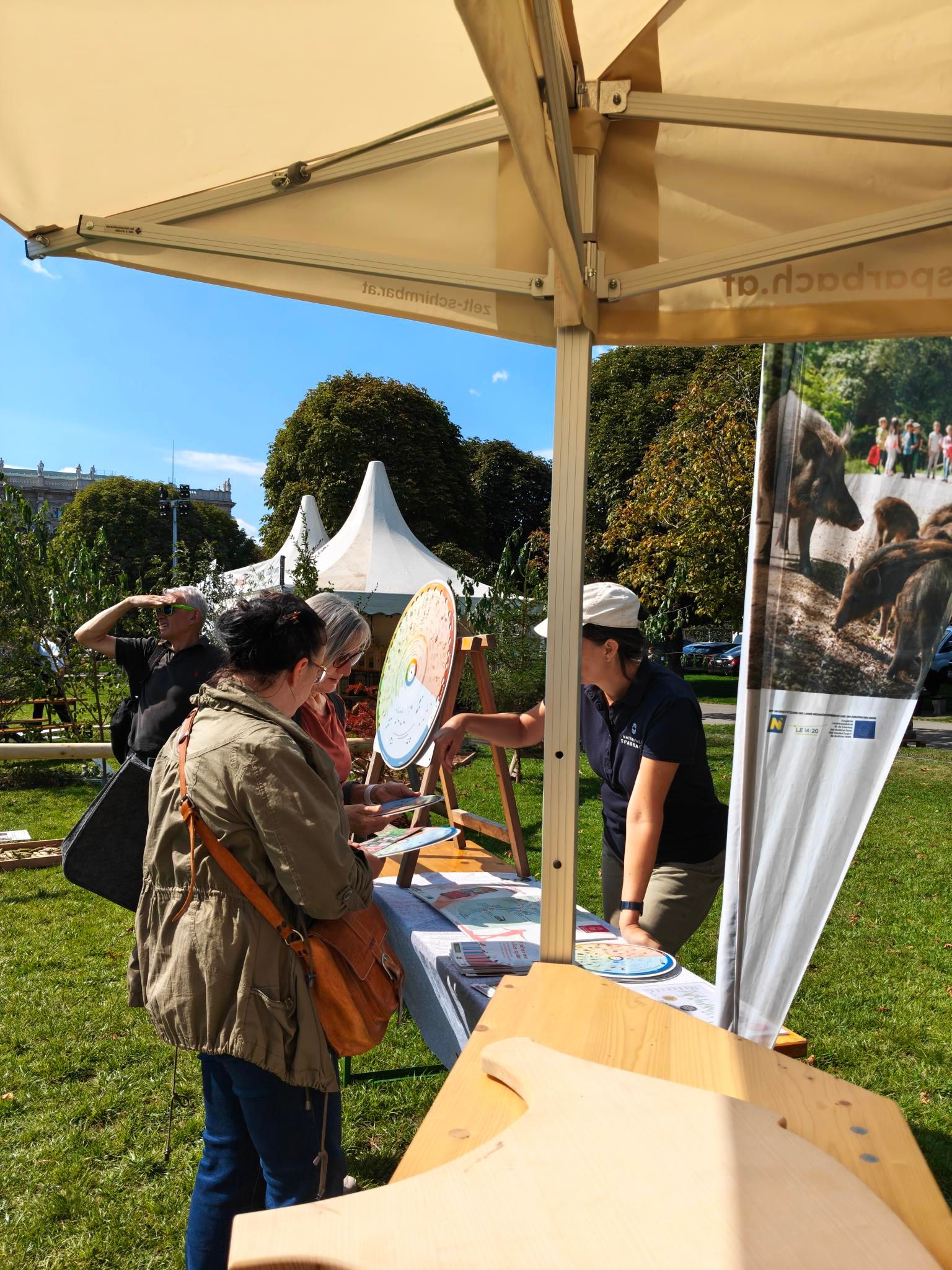 Besucher:innen lassen sich die Phänologische Scheibe erklären
