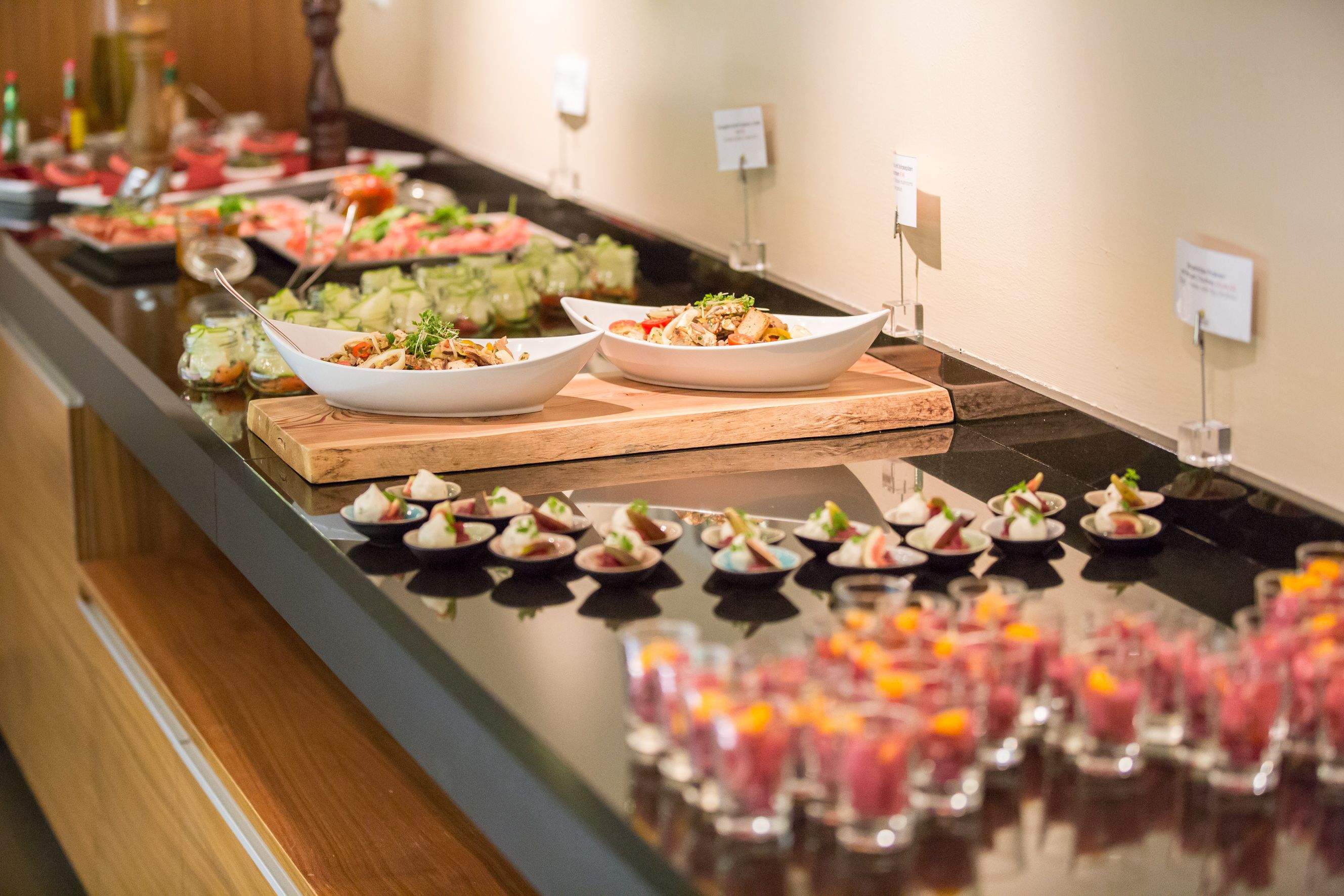 A buffet with various dishes on a table.